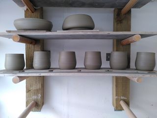 6 clay forms waiting to dry on a shelf