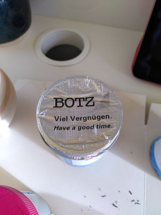 Top of a Botz glaze pot with "Have a good time" printed on the lid