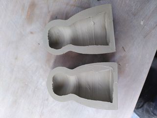 Two halves of a thrown clay form with very