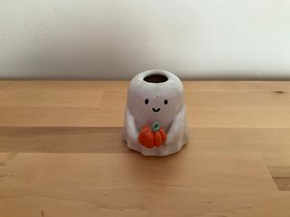 This little ghost vase is very prowd of the pumpkin it's showing you.

**Note**: Glaze shows some thinness and blistering at the top. The inside is watertight, though.