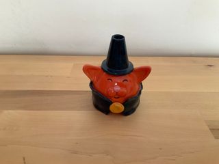 Bud vase in the shape of a friendly orange cat wizard, wearing a blue cone hat and cape held by a moon medallion.