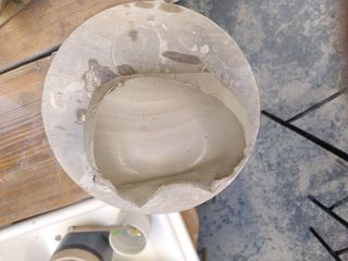 Thrown clay form half showing a very thin wall towards the top