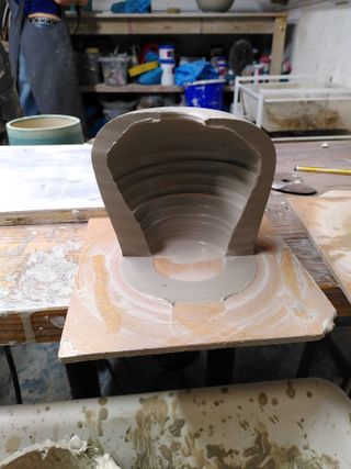 Smallest of the two forms cut in half, showing quite thick walls at the bottom