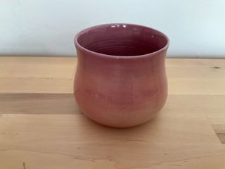 Bubbly planter glazed in peach colours outside (light orange to light purple) blending in a light purple inside.