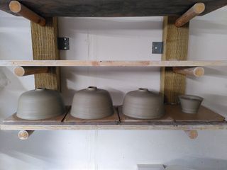 4 clay forms on a bat, 3 are table lamp bases with straightish walls curving into a short narrow neck, one is as small cup body.