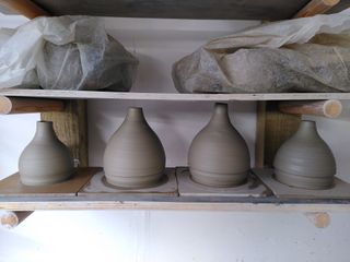 4 beside table bases, their bulbous base narrowing smoothly into a small neck