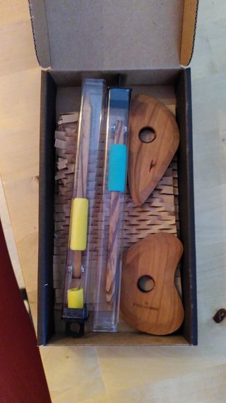 Two carving tools and throwing ribs in a cardboard box
