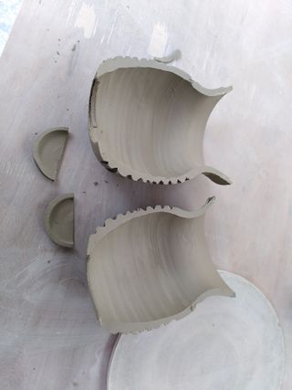 Haves of a carved vase, its bottom taken apart.