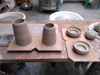 Two cones and two small tea-candle holders on their bat after throwing.
