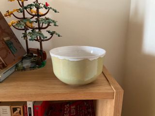 A flared bowl glazed in a textured application of yellow and light-blue green outside and white inside (overflowing at the rim).

**Note**: Inside glazing has a few [pinholes](https://community.ceramicartsdaily.org/topic/332-crazing-pinholes-and-food-safety/)