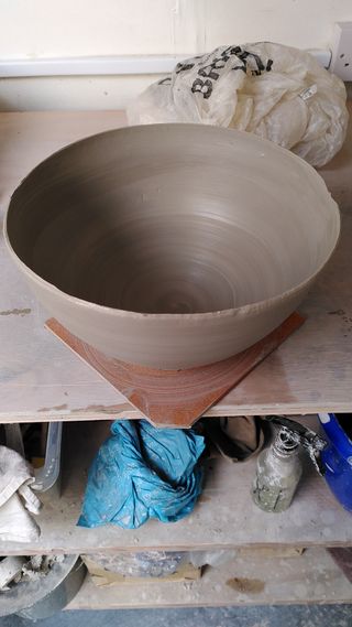 High angle picture of a large curvy bowl, its rim quite thin and a little irregular in places