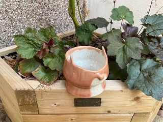 This little fox will happily host a small plant pot
