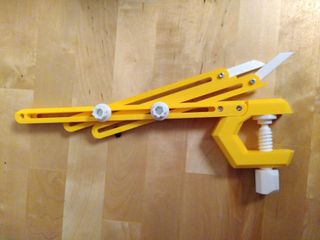 A yellow plastic double throwing gauge, folded on top of a table
