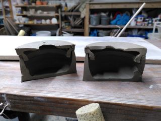 Half cuts of a clay jar with a broken lid after trimming