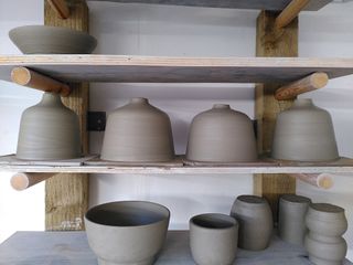 Close up on 4 bedside lamp bases with straight bodies curving into a short neck