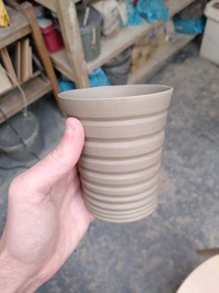 A flared tumbler with carved stripes