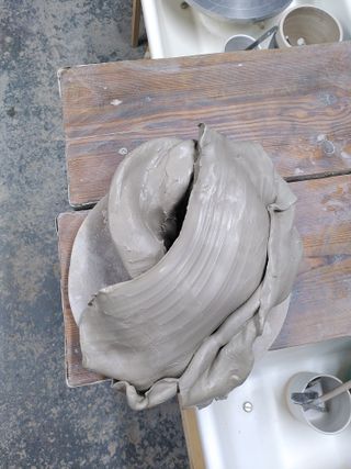 Stack of wet clay on a bat