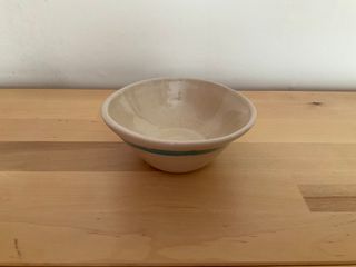 A little bowl with a slanted profile, clear glazed and adorned of a blue stripe, outside near the rim.