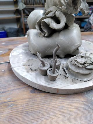 Failed attempts at thrown clay miniature plants in pots.