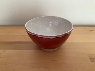 Bowl glazed red outside and with a white inside glaze overflowing outside at its top